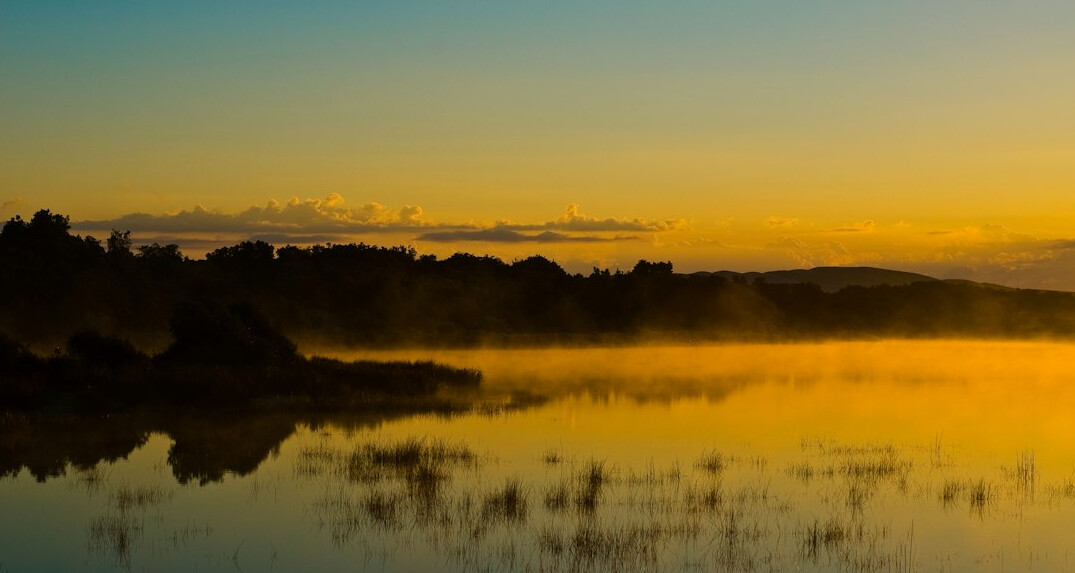 sunrise over calm landscape
